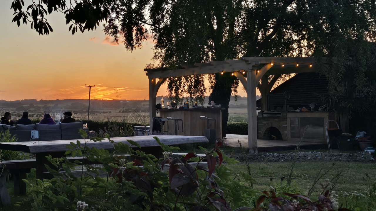 Evening scene with festoon lit oak pergola