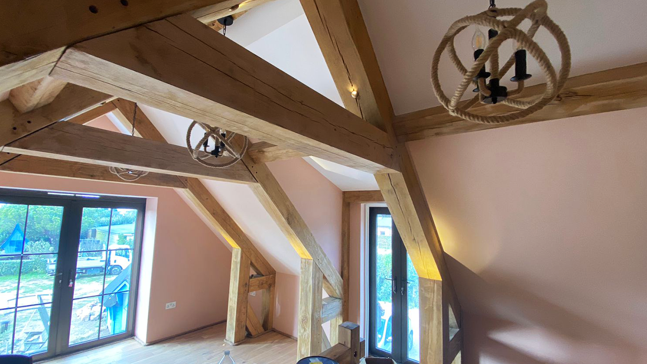 Exposed oak trusses in a loft conversion