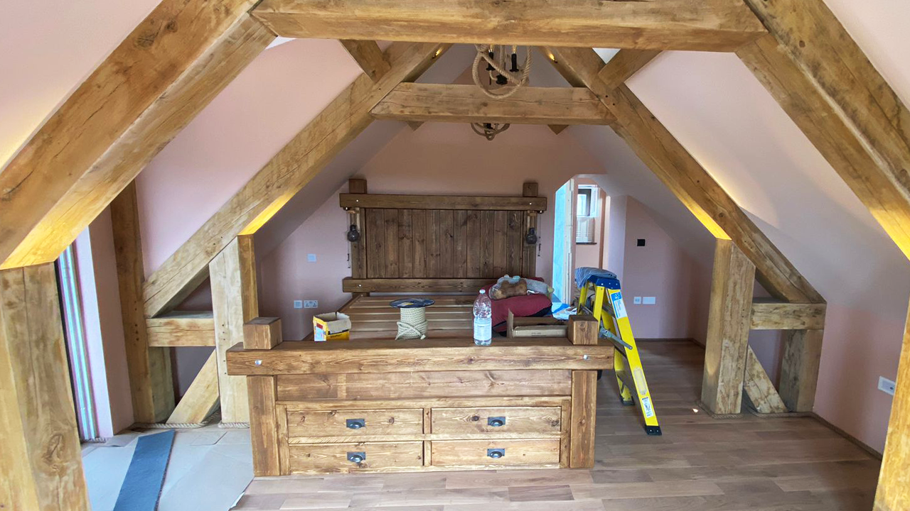 Exposed oak trusses make this loft space warm and cosy